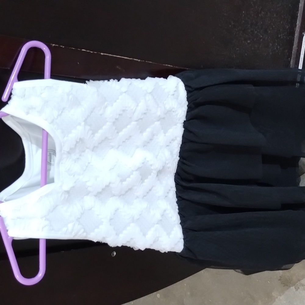 A kids party dress white and black made by Wonder Nation the size is 7/8
